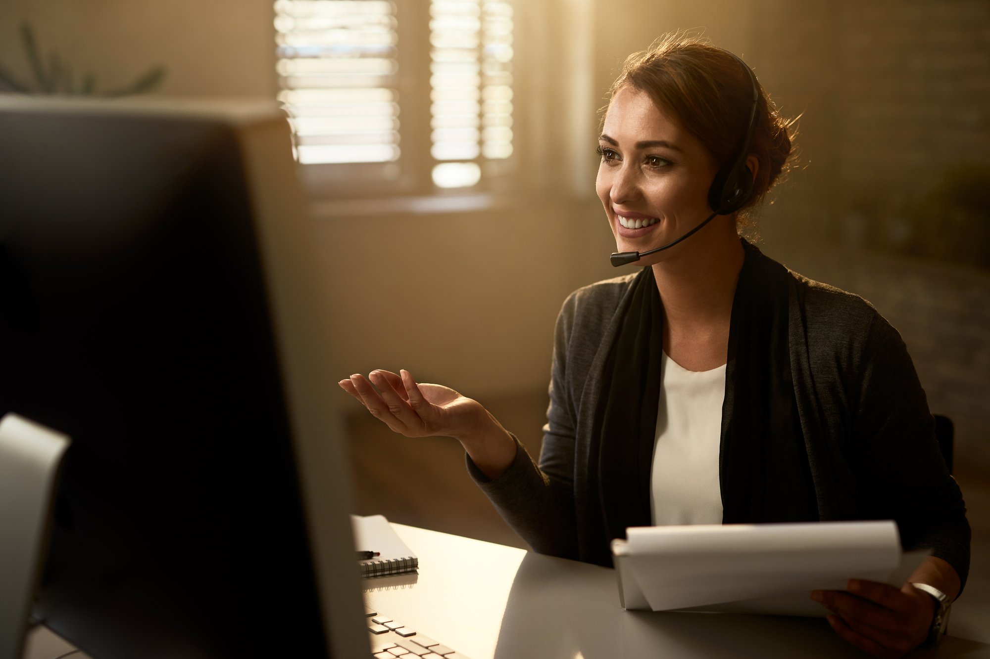 happy-customer-service-representative-using-computer-while-communicating-with-clients-online-1